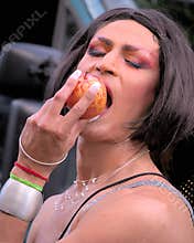Drag queen eating an apple