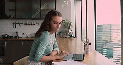 Female check papers, analyze contract details, working on laptop