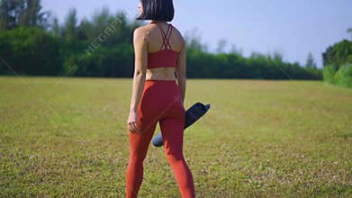 Asian chinese female yoga yogi choosing yoga exercise spot morning sun singapore
