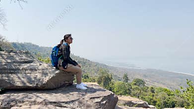 Woman tourists sit and admire the expansive views