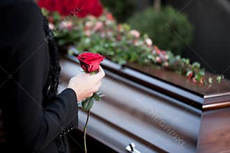 Woman at Funeral with coffin