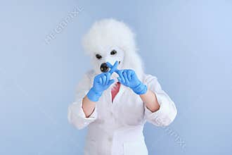 Young woman in a latex dog head mask and white coat making no or forbidden hand sign on a blue background