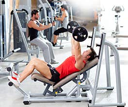 Group with weight training equipment on sport gym