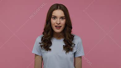 Girl opens her mouth in amazement, shouting wow, astonished.