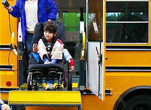 Disabled boy on bus wheelchair lift