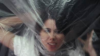 trapped woman freedom deprivation plastic wrap