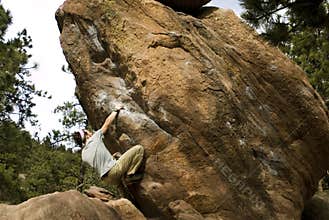 Man Climbing Boulder