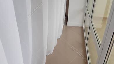 4k video, slow movement of the camera from top to bottom along the white nylon curtain on the balcony