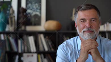 Business portrait - confident mature businessman in modern corporate office