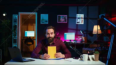 Man presenting and reading new novel from author for subscribers, promoting book