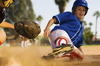 Softball Player Sliding Into Home Plate