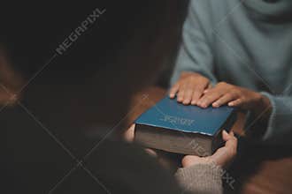 Christian group are praying to god with the bible and sharing the gospel. Concept of faith for god