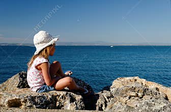 Girl on seaside rocks