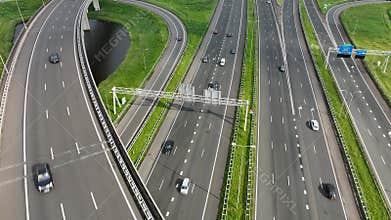 Aerial drone view of a multi-level highway intersection with moving cars near the city of Rotterdam,