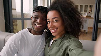 Happy affectionate couple ethnic African American family photo mobile phone at home smiling grimacing selfie camera