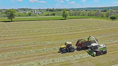 Harvest Dance: Tractors Bale Hay in Golden Fields with azure skies