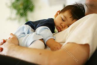 Baby sleeping on dad's chest