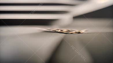 Two Gold Wedding Bands on a Grey Surface