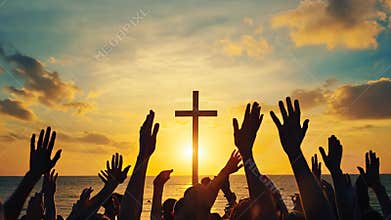 Hands are raised in worship in front of a cross at sunset