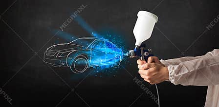 Worker with airbrush gun painting hand drawn car lines