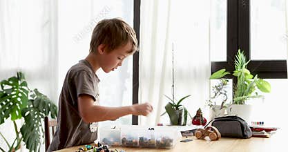 Young boy searching for missing l ego piece