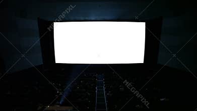 White cinema screen with projector light and audience in a modern cinema house.