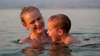 Mother playing with her young son in the beach