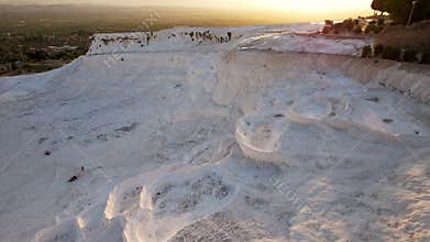 Aerial view of the travertines in Pamukkale in a beautiful sunset, Turkey. White limestone mineral formations. Turkish