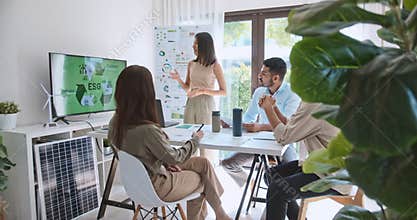 Asian woman lead young group of multiethnic businesspeople in team meeting, using laptop computer for ESG topic presentation