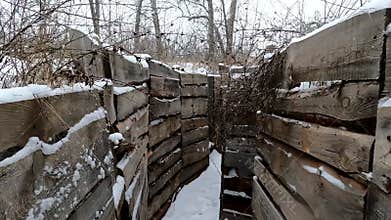 Trenches in the snow in winter. Move the camera forward. A real war. Military fortifications.