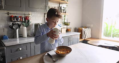 Cute school age boy prepare dry breakfast in the kitchen