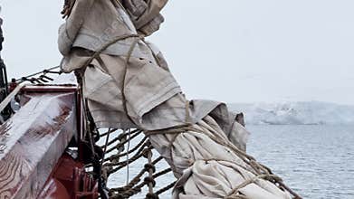 view from a retro style sailing schooner during the passage near the Antarctic peninsula at the South Pole, wooden boat