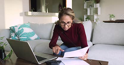 Older Latina woman do accounting job review spendings and savings