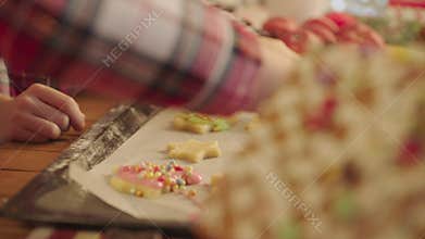 Cute boys making gingerbread icing cookies on Christmas Eve