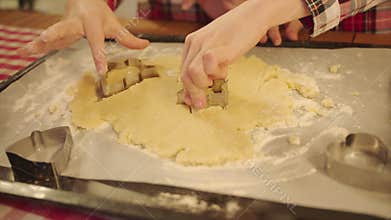 Cute boys making cookies form dough on Christmas Eve