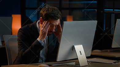 Exhausted Caucasian businessman adult man work overtime in office late night tired entrepreneur worried business problem