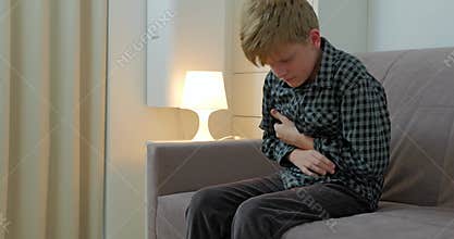 Little boy suffering from stomachache at home.The child has a stomach ache.