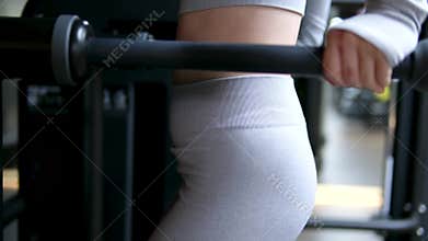 Woman doing pull-up. Strong girl in sportswear doing pull up exercise. Be H3althy