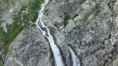 Aerial view of a huge mountain waterfall in the Alps or Caucasus