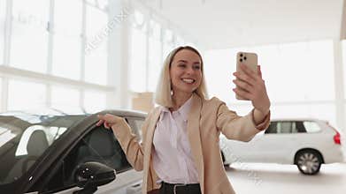 Successful businesswoman taking selfie using smartphone in car service.