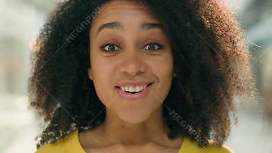 Close up happy African American woman looking at camera surprised wow shock delighted excited female girl model facial