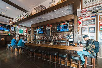 Casual conversations flow as easily as the drinks in a cozy, sports-decorated bar