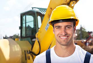 Friendly construction worker in front of his excavator