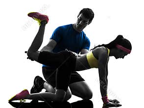 Woman exercising plank position fitness workout with man coach