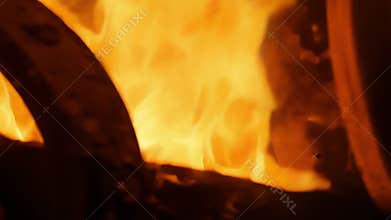 A closeup view captures the initial flickers of orange flame as the engine gradually builds up to a powerful inferno..