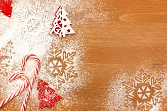 Christmas background with Candies, snowflakes and decorative Christmas Tree on wooden table