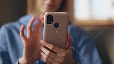 Woman hands scrolling mobile phone in home closeup. Lady choosing purchases
