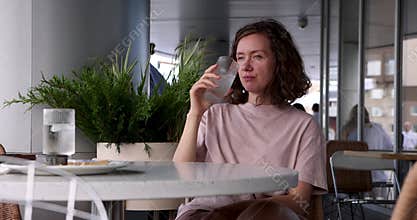 Contemplative woman modern cafe setting, enjoying moment of peaceful reflection while sipping coffee