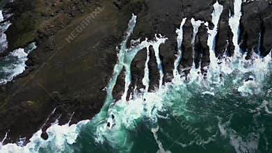 Drone View The Beauty of Waves Crashing Against Rocky Cliffs