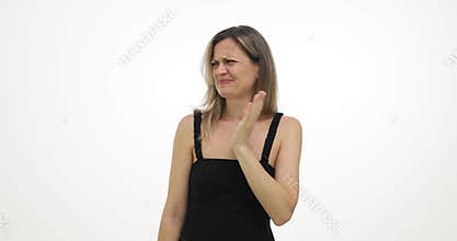 Woman covers nose with hand feeling unpleasant odor on white